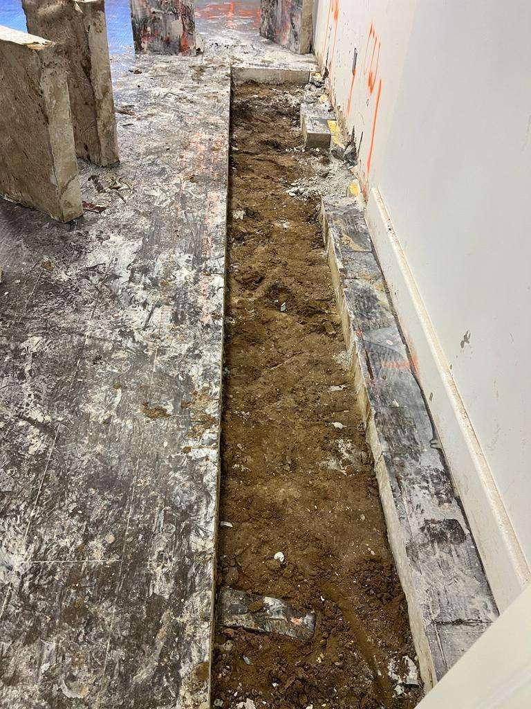Concrete trench cut in a bar floor by Helder’s Concrete Cutting Company to create a pathway for new plumbing installations