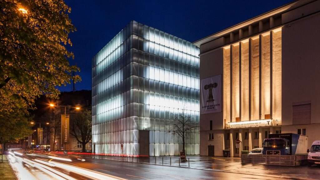 energy efficient building with translucent concrete facade glowing at night