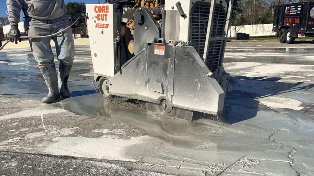 walk-behind concrete saw performing wet cutting on slab surface for precise concrete cutting