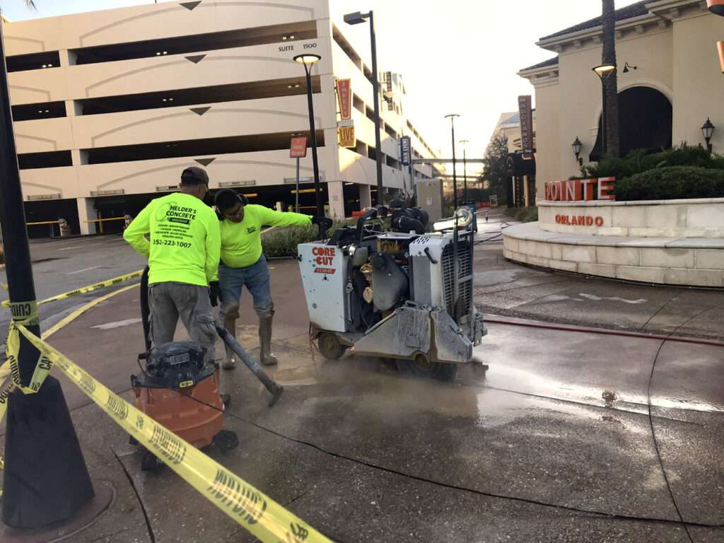 workers performing concrete cutting with slab saw in commercial area in Orlando Florida