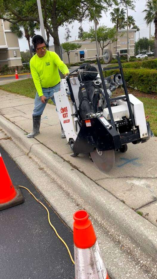 walk-behind concrete saw used for sidewalk concrete cutting in commercial site work
