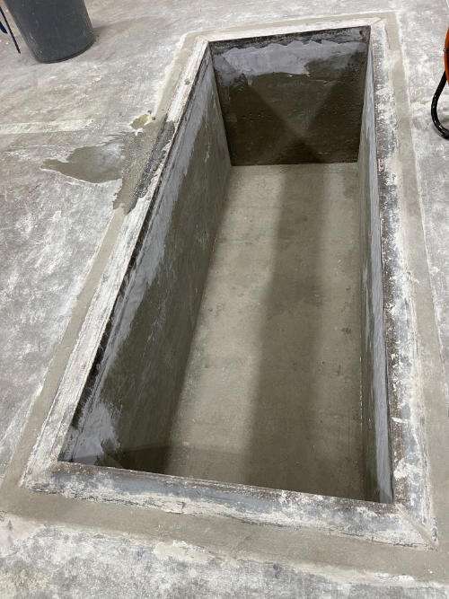 rectangular concrete floor opening cut for utilities showing precision construction work